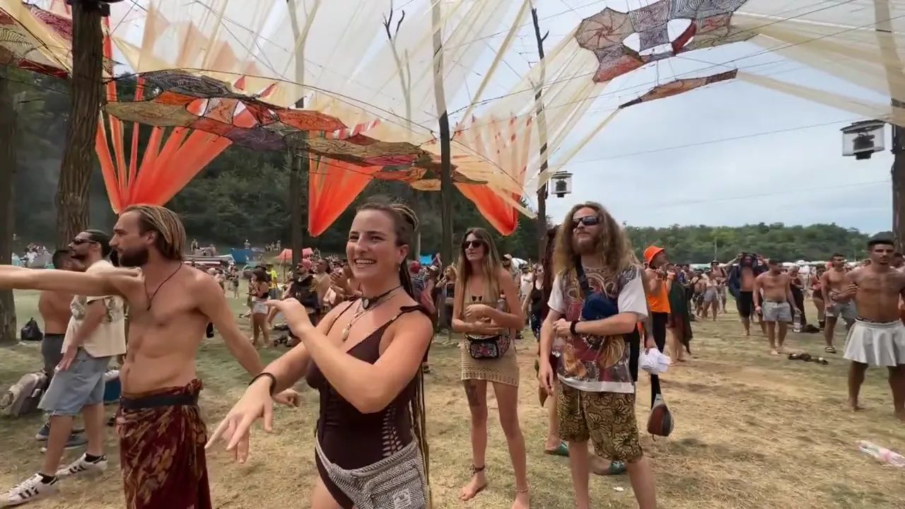 A woman with a flower wreath embraces the festival spirit