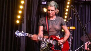 Guitarplayer and drummer in see through shirt after 0:00
