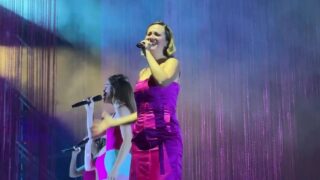 RIGOBERTA BANDINI and background singers flashing on stage