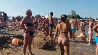 Topless girls on the beach at 3:57