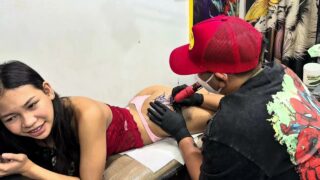Girl getting a tattoo on her sexy ass